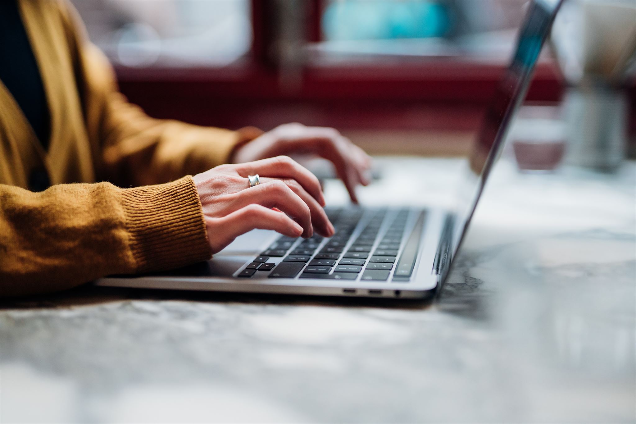 Hands-typing-on-laptop-keyboard